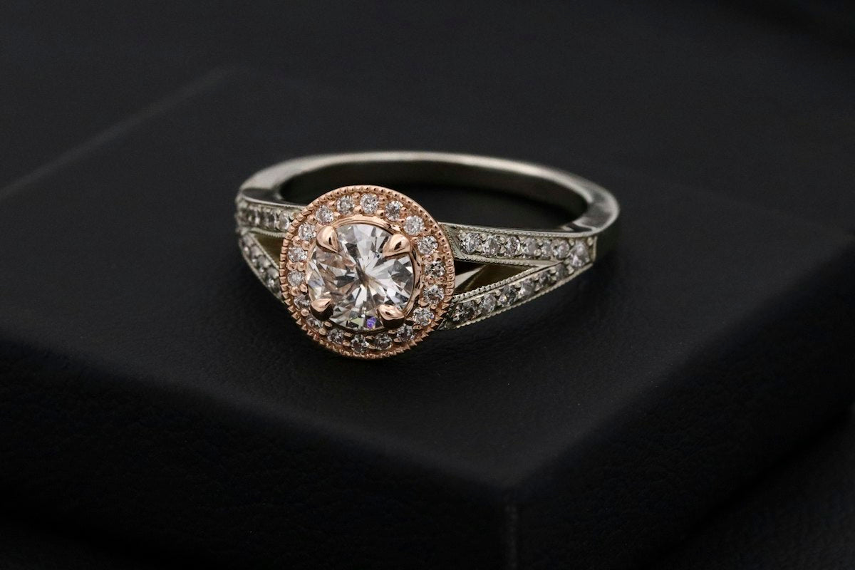 A gold ring being examined closely for its purity stamp
