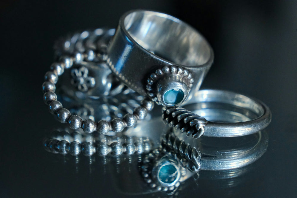Close-up of a silver ring band, where the 925 purity stamp is struck